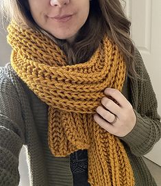 a woman wearing a yellow knitted scarf