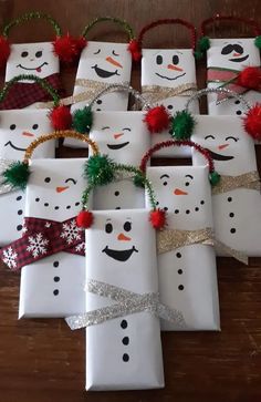 christmas presents wrapped in white paper with snowmen on them