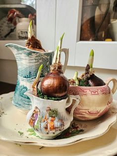 three tea cups with onions in them sitting on a plate next to another cup and saucer