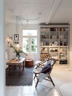 a living room filled with furniture and bookshelves