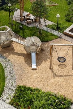 an aerial view of a playground with swings and slides