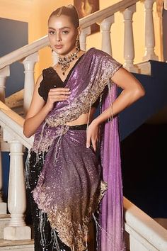 Purple polyester pre-draped saree with sequins embroidery. Comes with a black padded blouse.
Components: 2
Pattern: Embroidered
Type Of Work: Sequins
Neckline: V Neck
Sleeve Type: Sleeveless
Fabric: Polyester
Color: Purple
Other Details: 
Attached lining
Product Weight: 500 gms
Occasion: Wedding - Aza Fashions Glamorous Sequined Pre-draped Saree For Festivals, Bollywood Style Festive Pre-draped Saree With Sequins, Bollywood Style Pre-draped Saree With Sequins, Glamorous Designer Pre-draped Saree For Navratri, Fitted Pre-draped Sequin Saree For Festivals, Designer Pre-draped Sequin Saree For Diwali, Glamorous Draped Lehenga With Sheer Dupatta, Glamorous Draped Embellished Choli, Party Embellished Draped Dupatta