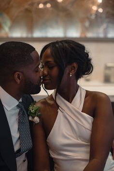 a man and woman are kissing each other