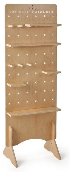 a wooden shelf with several shelves on each side and holes in the middle, along with two legs