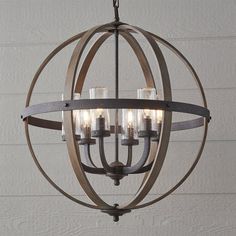 an orb chandelier with candles hanging from the center and four lights on each end