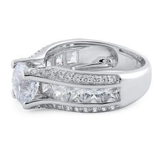 Top of ring height: 8mm

Top of ring width: 8.8mm

Band width: 7.5mm

Shank width: 4.7mm


Stone material: clear cubic zirconia

Center stone size: 8mm

Stone shape: round & princess cut

Center stone carat weight: 2.04 ct.

Total number of CZ stones: 51

Stone setting: prong setting


Metal: 925 sterling silver

Plating: rhodium plated

Finish: high polish Radiant Cut Ring With Channel Set Cubic Zirconia, Cubic Zirconia Princess Cut Wedding Ring With Accent Stones, Cubic Zirconia Asscher Cut Ring With Accent Stones, Princess Cut Cubic Zirconia Wedding Ring With Accent Stones, Cubic Zirconia Diamond Ring With Side Stones For Promise, Promise Diamond Ring With Side Stones In Cubic Zirconia, Channel Set Cubic Zirconia Diamond Ring, Cubic Zirconia Princess Cut Promise Rings, Cubic Zirconia Promise Ring With Side Stones