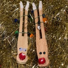 two wooden skis hanging from a christmas tree decorated with beads and stringed decorations