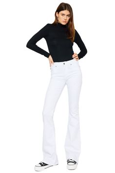 Our Alaska Mid Rise Jeans come in a classic flare cut in an opulent white color that was made to stand out. Sits right at the natural waistline as it gently tapers down the leg and begins to flare out at the calf. Made with super-stretch denim that keeps you feeling comfortable all day and won't bag out after each wear. Features a classic five-pocket design, single-button front, and zip-fly closure. 9" Rise   / 33.75" Inseam 66.5% Cotton, 31.3% Rayon, 2.2% Spandex Model in size 3/25 Style # : KC White Stretch Full-length Jeans, White Fitted Flare Bottoms, Fitted White Flare Bottoms, White Stretch Flare Jeans, White Stretch Flare Jeans For Fall, High Rise White Flares For Spring, White Chic Wide Leg Flares, White Stretch Flare Jeans For Spring, Chic White Wide Leg Flares