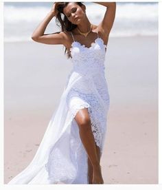 a woman in a white dress on the beach