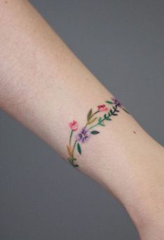 a woman's arm with flowers on it