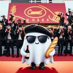 a white ghost with sunglasses and a bottle of wine in front of a group of photographers