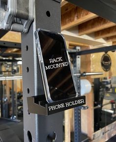 the back mounted phone holder is attached to a metal structure in a shop or workshop