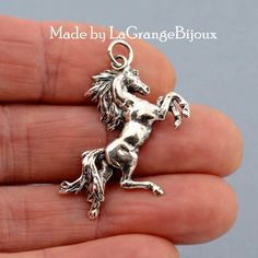 Made in 925 sterling silver this is a beautiful pendant of a rearing horse, 3cm tall, it makes a stunning gift for a horse lover. Our pendants are manufactured entirely in our workshop from design to casting using the age old process of Lost Wax Casting.   N.B. We do NOT provide chains with our pendants and charms. All our items are delivered in a presentation box and all packaging is included in the shipping. All items are sent using the French La Poste system with tracking You will receive an Silver Jewelry With Horse Design In Round Pendant, Silver Sterling Silver Jewelry For Shows, Horse Design Pendant Jewelry Gift, Rearing Horse, Horse Pendant, Horses Pendant, Wax Casting, Horse Lovers, Lost Wax Casting