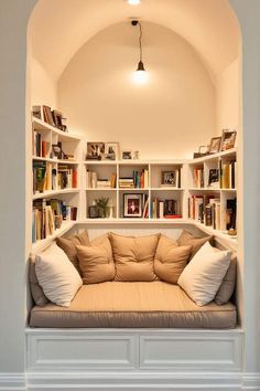 a living room filled with lots of books and furniture