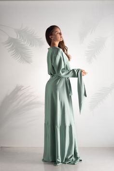 "Introducing our exquisite Mint Satin Abaya Dress, a luxurious blend of elegance and opulence. This enchanting garment features a lustrous mint satin fabric that drapes gracefully, exuding an air of sophistication and extravagance. The highlight of this abaya is its mesmerizing sleeve design, adorned with intricate embellishments and a unique silhouette that captivates all who lay eyes on it. Embrace the allure of timeless fashion with this statement piece, perfect for special occasions and crea Mint Satin Dress, Wrap Dress Formal, Style Wedding Guest, Satin Abaya, Women Robe, Dress Kimono, Satin Wrap Dress, Abaya Dress, Dress Satin