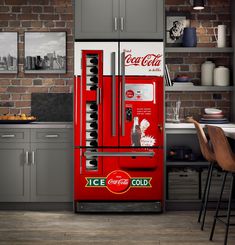 a coca - cola machine in the middle of a kitchen next to a table and chairs