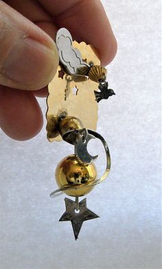 "A fantastic artsy Futuristic kinetic art pin with themes of Earth, Moon Galaxy in gold and silver metal. The gold ball is suspended on soldered wire with a silver ring and moon dangling around it. There is a cloud and bird with cut out stars. Very special and unique artisan pin. In great vintage condition. Measures 2 3/4\" long x 1 1/2\" wide x 3/4\" depth. Very Treky I will ship this item within one business day of receiving payment. Thank you. Enjoy For more Vintage Jewelry see my listings he Modernist Gold Brooches For Gifts, Unique Gold Pendant Brooches, Kinetic Jewelry, Moon Galaxy, Arm Bracelets Upper, Gold Galaxy, Coil Bracelet, Mixed Media Jewelry, Kinetic Art