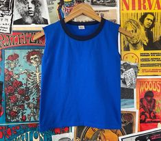 "Vintage kids 1980s blue two tone sleeveless ringer tank top shirt. Made of 100% cotton in the U.S.A. Is tagged a size medium, we estimate it to fit a kids 10, age 8/9, but please check measurements as this is an estimate. Has a small spot on back, but is in otherwise good, pre-owned condition. tag size | medium -- est. it to best fit kids size 10, age 8-9 *refer to measurements for sizing as this is an estimate measurements: chest -- 28\" total length -- 17\"" Retro Sleeveless Cotton T-shirt, Retro Cotton Muscle Tee Sleeveless, Retro Sleeveless Muscle Tee In Cotton, Retro Cotton Sleeveless Muscle Tee, Retro Blue Sleeveless Top, Vintage Blue Summer Vest, 90s Style Blue Sleeveless Tops, Vintage Blue Sleeveless Vest, Vintage Blue Sleeveless Top