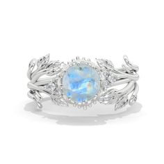 a ring with an oval blue opal surrounded by leaves and white diamonds on the sides