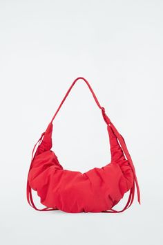 Named for its artfully ruched shape, the Canopy bag has drawstring ties at either side that pull in to create its signature gathered silhouette. It's made from padded nylon and has an ample zipped compartment. Zip closureRecycled nylon reduces our demand on limited natural resources and reduces greenhouse gas emissions   Shell: 73% Recycled polyamide (Recycled nylon), 27% Cotton. Lining: 50% Cotton, 50% Recycled cotton. Padding: 100% Recycled polyester. Excluding trims Height: 13.77", Width: 33. Cos Bags, Mens Straw Hats, Cutout Skirt, Padded Bag, Jodhpur Boots, Object Design, Wool Mini Skirt, Red Bag, Luxury Purses