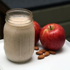 an apple cinnamon smoothie in a jar with almonds