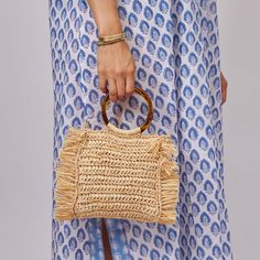 Fringed straw bag with a round tortoise handle and optional crossbody strap, our Tort bag is one of our spring and summertime favorites! Product Overview: Material: 100% Raffia; Lining- 100% Linen; Handles- 100% Plastic 17cm x 16cm: Strap Length 120cm Spot Clean with Damp Cloth Fringe Bags, Crossbody Strap, Tortoise, Straw Bag, Straw, Handles