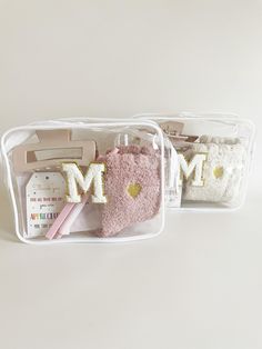 two plastic containers filled with personal items on top of a white table next to each other