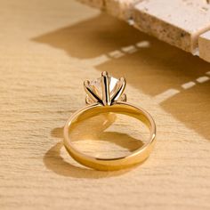 a gold ring sitting on top of a wooden table