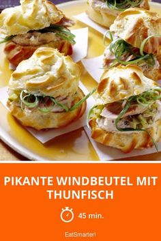 there are many sandwiches on the plate with green garnishes in them and text that reads pikante windbeutel mit thunfisch