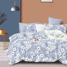 a bed with blue and white flowers on it