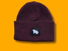 Capibara handmade labeled beanie to keep your head warm in cosy winter days.  This beanie is a 'one size fits all' winterbeanie in Burgundy Classic Red Knitted fabric. It is a perfect gift for yourself or maybe for a special occasion that includes your best friend, mom, brother, sister, grandma or make this your dad's new winterhat. In these freezing days of the winter it will make you look very stunning in the snow or in on your chill out session at the campfire. Or maybe just for your trip dow Snug Beanie For Cold Weather, Knitted Cotton Winter Bonnet, Warm Fitted Beanie For Cold Weather, Red Winter Beanie, One Size Fits Most, Red Winter Beanie One Size Fits Most, Winter Cotton Beanie, One Size, Adjustable Wool Beanie For Winter, Warm Cotton Beanie Bonnet, Snug Beanie Hat For Fall