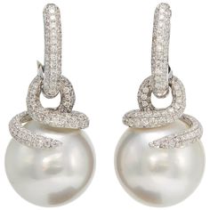 18K White Gold drop earrings featuring two South Sea Pearls measuring 14-15 mm flanked with numerous diamonds weighing 1.55 carats. Comes in Rose Gold Pearl Diamond Dangle Earrings, White Gold Drop Earrings, Earrings Multiple, South Sea Pearls Earrings, Gold Chandelier Earrings, Black Earrings Dangle, Pearl And Diamond Earrings, Diamond Dangle Earrings, Earrings Diamond