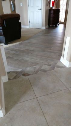 a living room with hard wood floors and white trim