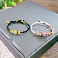 two bracelets sitting on top of a book