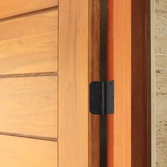 a close up of a door handle on a wooden door