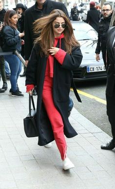 a woman with long hair walking down the street