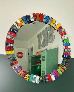 there is a mirror that has cars on it in the shape of a circle,