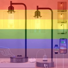 three lights that are next to each other in front of a rainbow colored wall with two cell phones