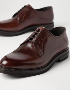 Cordovan Derbys Exquisite and timeless cordovan leather renews an iconic men's formal footwear design. Slight nuances of color enrich the leather's polished, even texture, while the silhouette of the upper and the thickness of the outsole are balanced to update the shoe’s classic aesthetic with a modern touch, in true Brunello Cucinelli style. Luxury Brown Derby Shoes For Semi-formal, Elegant Goodyear Welted Calf Leather Shoes, Timeless Italian Oxfords For Semi-formal Occasions, Luxury Goodyear Welted Oxfords For Semi-formal Occasions, Timeless Brown Derby For Formal Occasions, Luxury Plain Toe Dress Shoes, Goodyear Welted, Luxury Plain Toe Dress Shoes With Goodyear Welted, Classic Italian Crafted Dress Shoes For Business, Classic Italian Business Dress Shoes