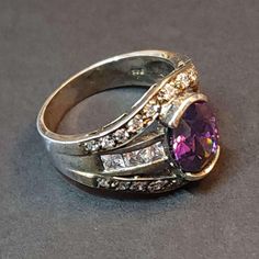 Vintage Size 8 Sterling Silver Ring, Amethyst CZ Statement Ring February Birthstone, Oval Purple CZ Ring Birthday Gift This is a spectacular vintage ring with beautiful craftsmanship.  This ring is from 2000 or earlier. It's in great condition, unworn, antiqued and tarnished. It's been in storage all of these years. AMETHYST CZ is the birthstone for February. All vintage sterling silver jewelry may have antiquing or tarnish. See all of our amethyst jewelry here: https://www.etsy.com/shop/BlueMoo Dazzling Amethyst Anniversary Ring, Elegant Multi-stone Birthday Rings, Dazzling Purple Oval Rings, Amethyst Ring With Cubic Zirconia Accents For Anniversary, Oval Multi-stone Birthstone Ring, Oval Amethyst Ring With Accent Stones For Anniversary, Oval Gemstones With Stone Setting For Anniversary, Dazzling Purple Rings For Anniversary, Oval Amethyst Ring With Cubic Zirconia And Gemstone Accents