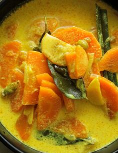 a close up of a bowl of food with carrots and asparagus