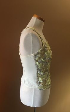 "Beautiful and unusual camisole accented with metallic floral appliqués. The top is made of nylon and Lycra for a slimming effect. Staves are added for a mild support and to maintain a slimming look. Top can be worn with jeans as well as slacks or skirt. Measures 16\" from armpit to armpit 10.5\" from armpit to hem 13\" across the waist This top has a lot of stretch!" Spring Party Corset With Spaghetti Straps, Party Lace Tops With Boned Bodice, Spring Lace Camisole Corset, Boned Bodice Tops For Night Out In Spring, Boned Bodice Top For Spring Night Out, Spring Lace Corset, Spring Stretch Corset With Boned Bodice, Spring Stretch Cami Corset, Stretch Cami Corset For Spring