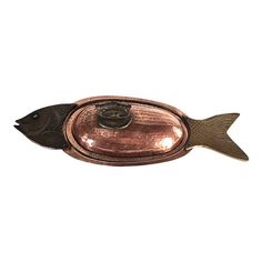 a small metal fish with a light on it's side