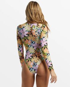 Styled with a V-neck, functional front tie, and a keyhole cutout, the Mas Aloha Long Sleeve Swimsuit stands out from the rest of the lineup. This printed swimsuit is made with partially recycled Peach Stretch fabric offering enhanced sun protection because the more time you spend in the water, the more fun you have. Fabric: 85% Recycled polyester 15% elastane blend peach stretch fabric UV Protection: UPF 50+ sun protection Fit: Classic fit Neck: Scoop front neck Sleeves: Long sleeves Coverage: B Long Sleeve Floral Print Stretch Swimwear, Long Sleeve Floral Print Swimwear For Surfing, Multicolor Long Sleeve Swimwear For Poolside, Long Sleeve Floral Print Swimwear For Beach Season, Long Sleeve Tropical Print Swimwear, Long Sleeve Tropical Print Beachwear, Long Sleeve Tropical Print Swimwear For Spring, Printed Long Sleeve Bodysuit For Beachwear, Printed Long Sleeve Beachwear Bodysuit