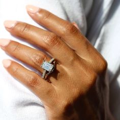 a woman's hand with a diamond ring on it