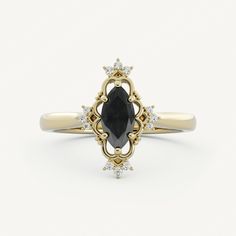 an oval shaped black diamond ring set in yellow gold with diamonds around the band and center stone