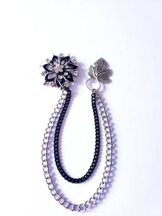 Looking for an accessory that exudes elegance and sophistication? Introducing our Elegant Crystal Lapel Pin with Silver/Black Chains! It is a stunning brooch pin designed for suits, tuxedos, blouses, and more. Made of high-quality crystal, alloy, and steel materials. This fashionable lapel pin serves as the perfect gift for both men and women, adding a touch of glamour to formal clothing, suits, and wedding attire. Its versatility makes it an ideal choice for various occasions. You can even pers Formal Metal Brooch Pin, Elegant Metal Brooches For Parties, Black Metal Brooch Jewelry, Black Brooch For Formal Occasions, Black Formal Brooch Lapel Pin, Black Formal Lapel Brooch, Black Brooch Pins For Evening, Black Brooch Jewelry For Wedding, Silver Brooch With Chain For Formal Occasions