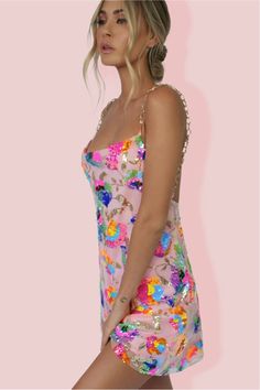 The Celebration Time Sequin Backless Mini Dress is the only reason you'll need to start the celebration! Crafted from embellished mesh overlay with delicate embroidered fluorescent and pastel flowers & sequins together with 100% poly lining. This gorgeous mini has a relaxed oversized fit throughout with a cowl neckline & plunging back. The stunning gold strap detailing attach near the bust with a super low back. Featuring a super cute flowy hem to create a flirty feel to this slip -making it a p Selena Dresses, Multicolor Sequins, Soft Tulle, Backless Mini Dress, Shades Of White, Flowy Skirt, Pastel Rainbow, White Mini Dress, Sequin Dress