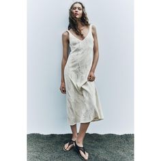 V-Neck Midi Dress With Wide Straps. Textured Fabric Detail. A-Line Silhouette. Elegant V-neck Sundress For Day Out, Viscose V-neck Midi Dress For The Beach, Beige V-neck Sundress For Day Out, Beige V-neck Linen Dress For Beach, Beige V-neck Slip Dress For Summer, Cream V-neck Dress For Day Out, Beige V-neck Sleeveless Dress For Vacation, Chic V-neck Linen Dress For Day Out, Beige V-neck Sleeveless Summer Dress