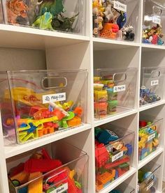 the shelves are filled with plastic toys and bins for storing children's toys